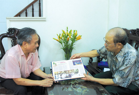 Nguyên Tổng Biên tập Lê Ngọc Toàn (trái) và nguyên Phó Tổng Biên tập Nguyễn Văn Thúy xem lại số báo kỷ niệm 10 năm tạp chí Người Đại biểu Nhân dân